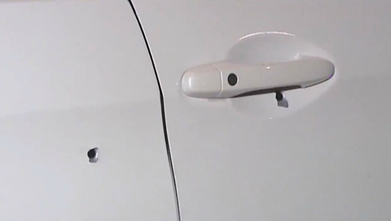 d69c40f5-You can see the bullet holes in this car door; the shooting happened on the Kennedy Expressway in Chicago