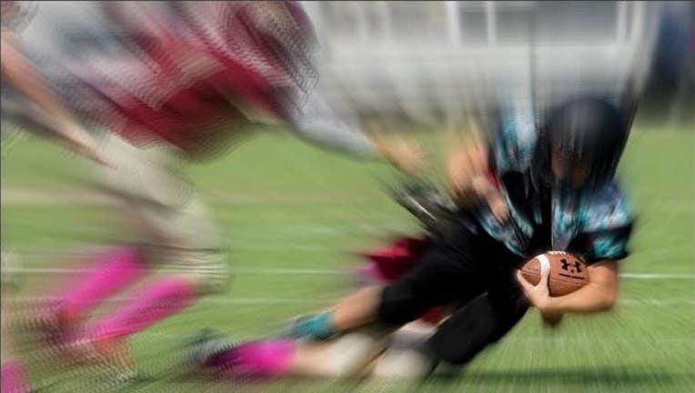 Kids playing football image by C Watts via Flickr