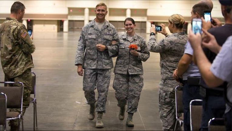 e36ea351-Florida National Guard Senior Airmen Lauren Durham and Michael Davis exchanged vows in Orlando before helping with hurricane recovery