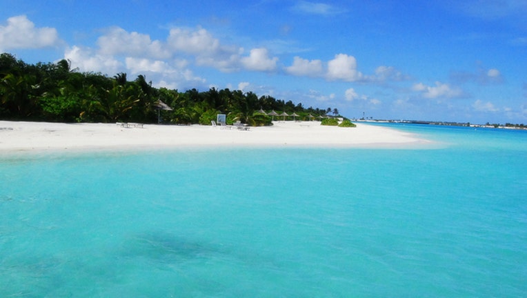 f522e8da-Maldives tropical resort island stock photo by Elena N via Flickr