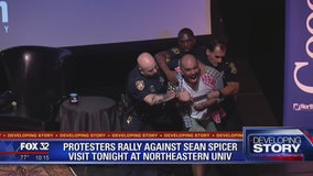 Protesters rally against Sean Spicer during his visit to Chicago