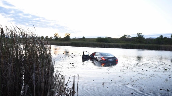 Woman escapes vehicle after it plunges into Aurora retention pond