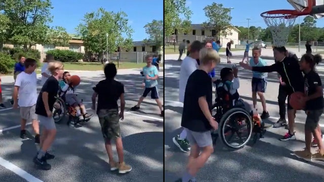 Kids cheer on classmate in wheelchair, help him score during basketball game