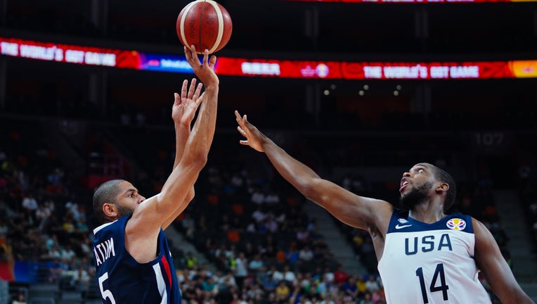 Nicolas Batum #5 of France shoots the ball against Khris Middleton #14 of USA during FIBA World Cup 2019 quarter-final match between the United States and France at Dongguan Basketball Center on September 11, 2019 in Dongguan, Guangdong Province of China. (Photo by VCG/VCG via Getty Images)