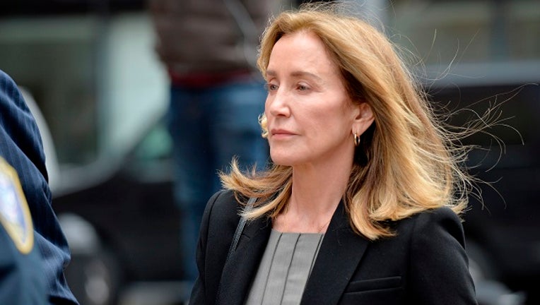 Actress Felicity Huffman is escorted by Police into court in Boston, Massachusetts, May 13, 2019.