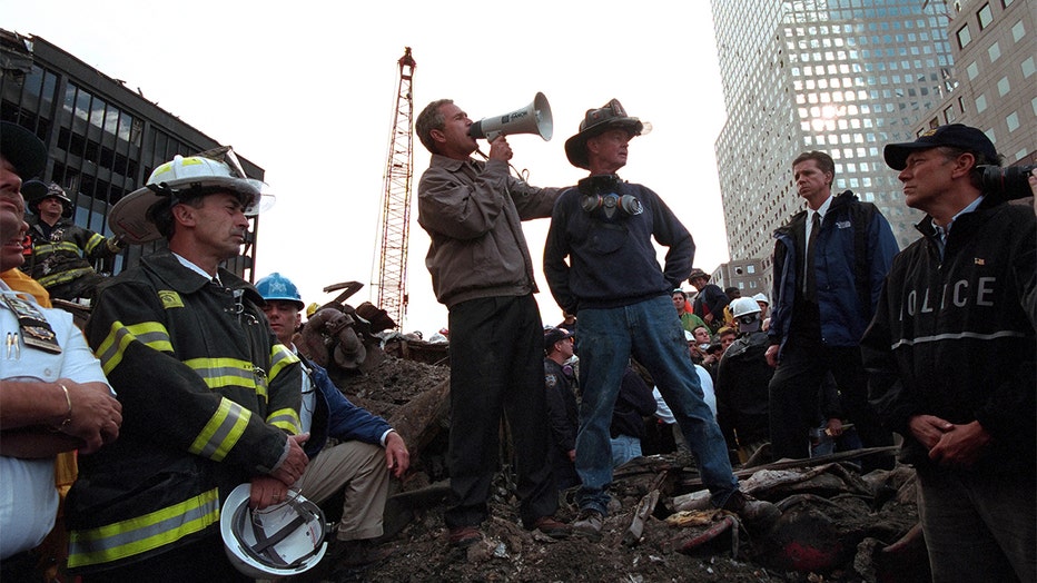 President George W Bush rallies firefighters and rescue workers during an impromptu speech at the site of the collapsed World Trade Center.