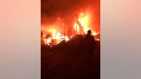 Junkyard fire destroys at least 40 vehicles, one house