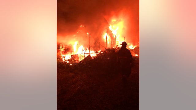 Junkyard fire destroys at least 40 vehicles, one house