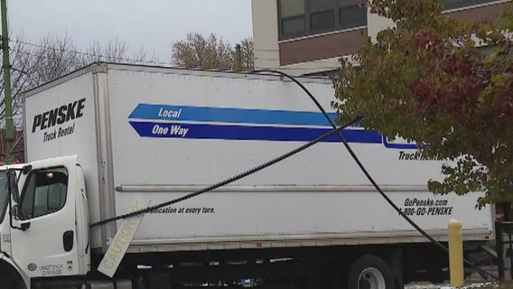 Electrical pole falls on car after truck snags power lines in Lincoln Park