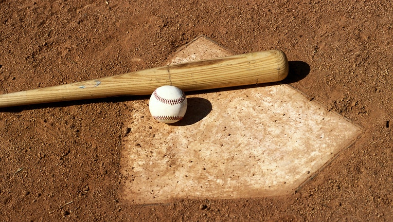 GETTY Stock image of baseball, baseball bat and home plate