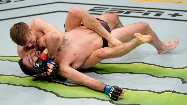 WASHINGTON, DC - DECEMBER 07: (L-R) Bryce Mitchell grapples with Matt Sayles in their featherweight bout during the UFC Fight Night event at Capital One Arena on December 07, 2019 in Washington, DC. (Photo by Jeff Bottari/Zuffa LLC via Getty Images)