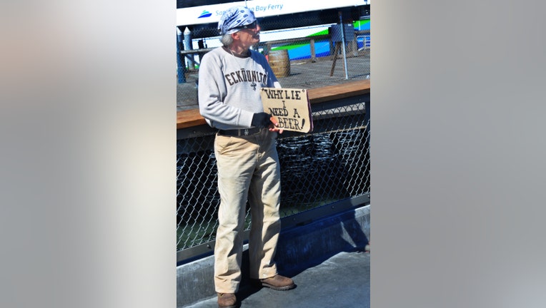 SAN FRANCISCO, CA - MAY 16, 2013: A 'panhandler' with a sense of humor solicits handouts at San Francisco's Fisherman's Wharf district, a popular shopping, entertainment and restaurant complex. (Photo by Robert Alexander/Archive Photos/Getty Images) 