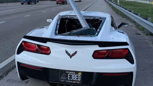Roadway sign goes airborne, slices through rear window of Corvette on Florida highway