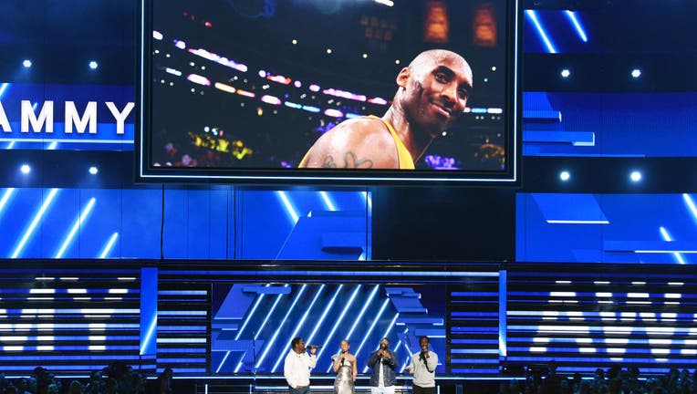 LOS ANGELES, CALIFORNIA - JANUARY 26: An image of the late Kobe Bryant is projected onto a screen while host Alicia Keys (2nd from L) and (from L) Nathan Morris, Wanya Morris, and Shawn Stockman of music group Boyz II Men perform onstage during the 62nd Annual GRAMMY Awards at STAPLES Center on January 26, 2020 in Los Angeles, California. (Photo by Kevin Winter/Getty Images for The Recording Academy )