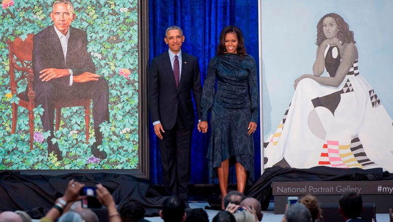 TOPSHOT - Former US President Barack Obama and First Lady Michelle Obama stand beside their portraits after their unveiling at the Smithsonian's National Portrait Gallery in Washington, DC, February 12, 2018. (Photo by SAUL LOEB / AFP) / RESTRICTED TO EDITORIAL USE - MANDATORY MENTION OF THE ARTIST UPON PUBLICATION - TO ILLUSTRATE THE EVENT AS SPECIFIED IN THE CAPTION (Photo credit should read SAUL LOEB/AFP via Getty Images)