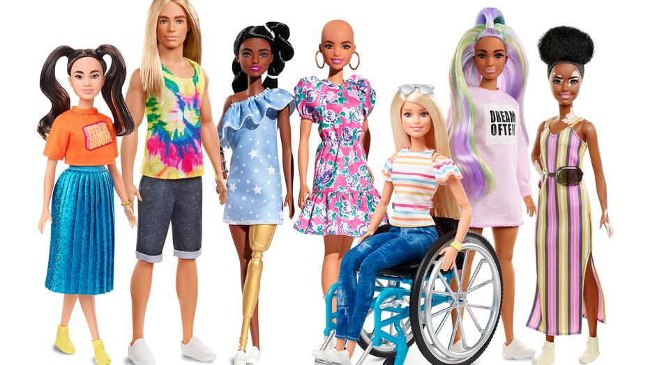 New dolls in Barbie’s 2020 Fashionistas lineup include a Ken doll with long, rooted hair, a doll with darker skin and a gold prosthetic limb, a doll with no hair and a doll with the skin condition vitiligo. (Photo credit: Mattel)