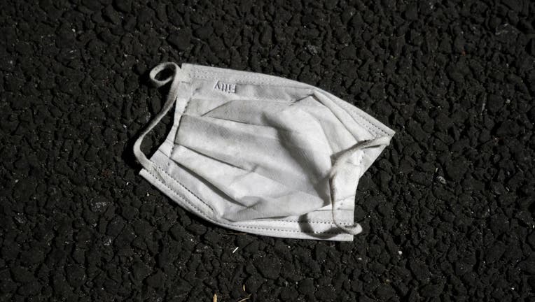 A face mask lies discarded on the ground near the cruise ship terminal where the quarantined Diamond Princess cruise ship was docked at the Daikoku Pier on Feb. 20, 2020 in Yokohama, Japan. (Photo by Tomohiro Ohsumi/Getty Images)