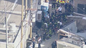 Firefighters rescue person trapped under debris following garage collapse on the North Side