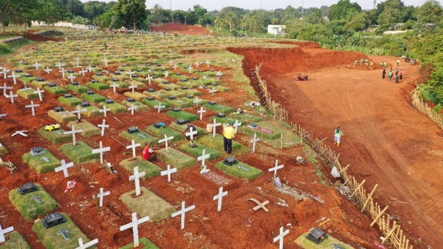 Indonesian official orders coronavirus victims' graves be dug by people busted without masks