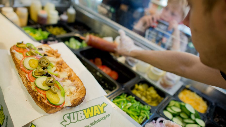 Subway employee making sandwich