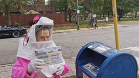 102-year-old former CPS worker dresses in hazmat suit to vote