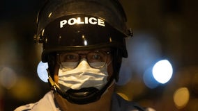 Should police be required to wear masks? Some cities say no