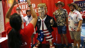 Gold-colored Trump statue at CPAC drawing crowds