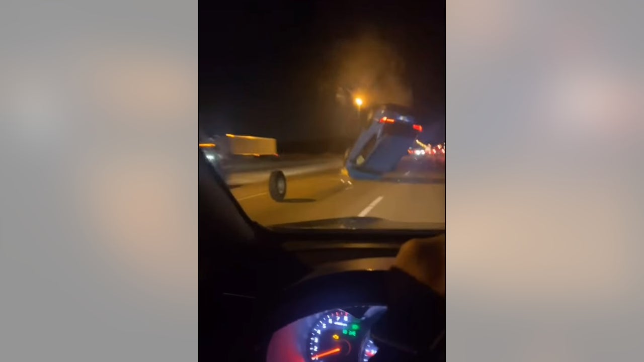 Driver goes airborne after hitting wheel rolling down highway, video shows