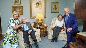 Bidens, Carters pose for a photo during visit to Plains