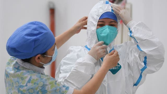 Uptick in coronavirus cases prompts Chinese city to lock down neighborhood