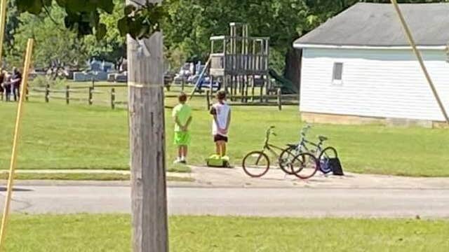 Boys hop off their bikes, pay respects during military veteran's funeral