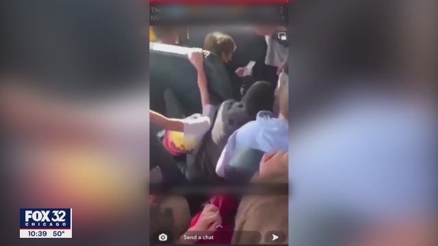Video surfaces of Minooka student being put in head-lock, pinned to seat on school bus