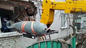 Ukrainians remove unexploded Russian bomb from damaged home, video shows