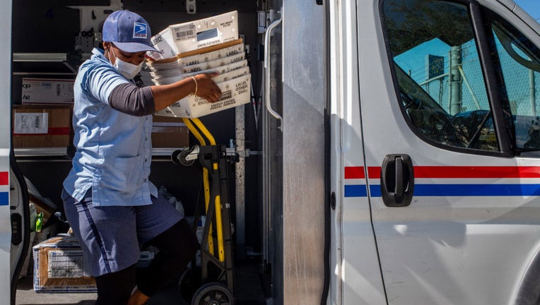 Postal worker unloads mail