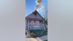 Driver notices home on fire in Aurora, pounds on door to save family inside