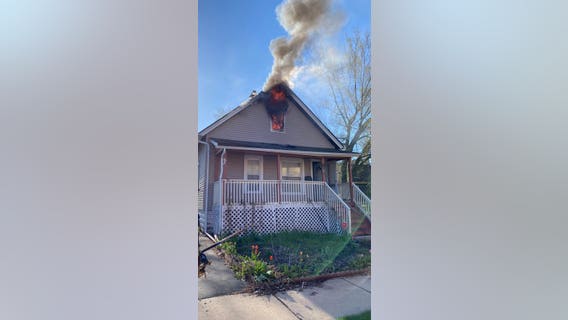 Driver notices home on fire in Aurora, pounds on door to save family inside