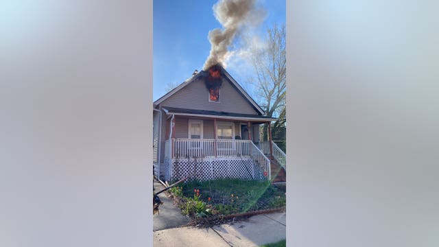 Driver notices home on fire in Aurora, pounds on door to save family inside
