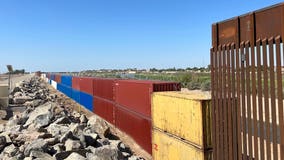 Gaps in Arizona border wall filled with double-stacked shipping containers