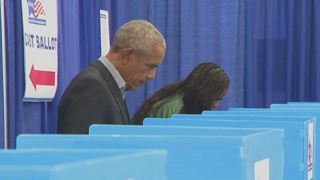 Barack and Michelle Obama return to Chicago to vote, surprise students