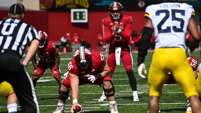 Michigan assistant coach Hart carted off Indiana's field on backboard