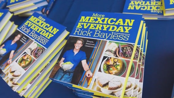 Rick Bayless signs cookbooks and gives out guacamole samples to fliers at O'Hare Airport