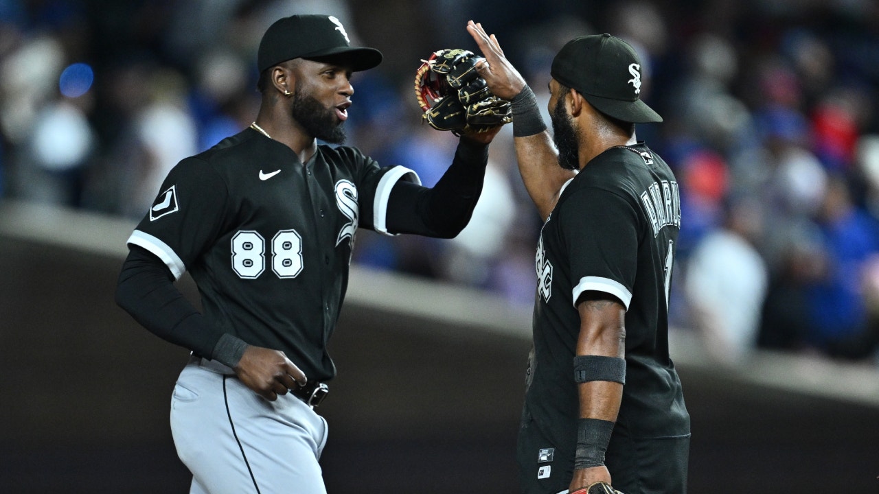 Luis Robert Jr. #88 and Andrew Benintendi of the Chicago White Sox