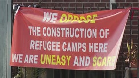 Brighton Park residents rally against migrant camp as construction equipment arrives