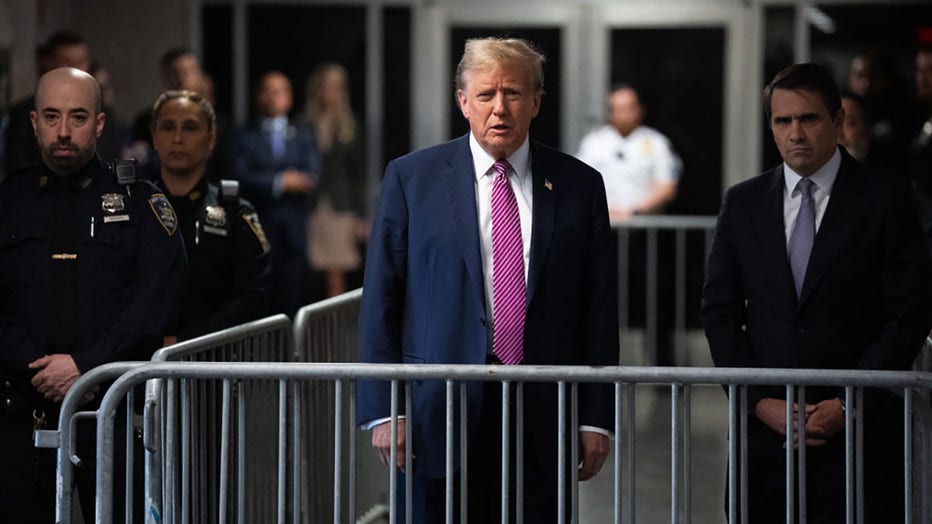 FILE - Former US President Donald Trump speaks to the media with his lawyer Todd Blanche (R) after leaving the courtroom for the day at Manhattan Criminal Court during his trial for allegedly covering up hush money payments linked to extramarital affairs, in New York City on April 19, 2024. (Photo by MAANSI SRIVASTAVA/POOL/AFP via Getty Images)