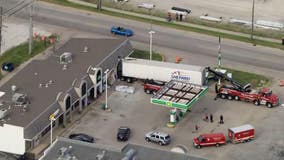 Driver rescued after semi-truck crashes into gas station in far south suburbs