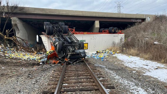 Semi-truck drives off I-55 near Plainfield, rolls onto train tracks