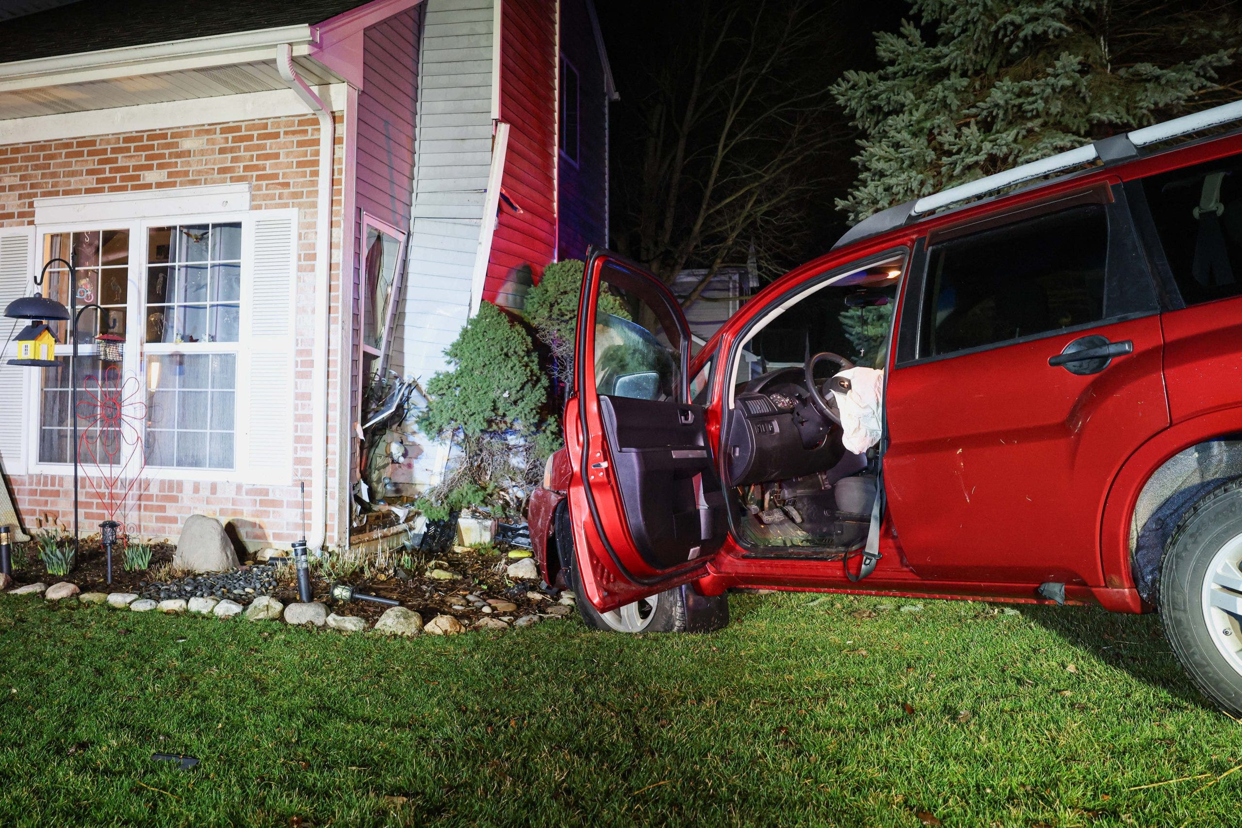 Car crashes into suburban Chicago home and narrowly misses resident, officials say