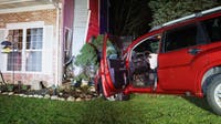 Car crashes into suburban Chicago home and narrowly misses resident, officials say