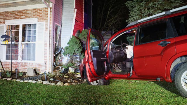 Car crashes into suburban Chicago home and narrowly misses resident, officials say