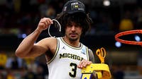 Michigan's Elliot Cadeau gets medical attention before traveling to Final Four